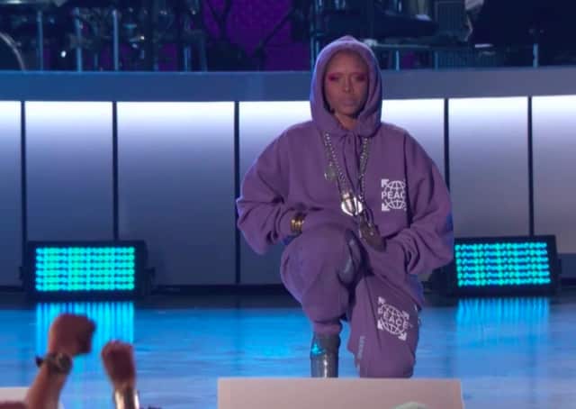 Image result for Erykah Badu takes a knee for Collin