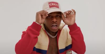 DaBaby flexes at a photoshoot for the “PEEPHOLE” music video