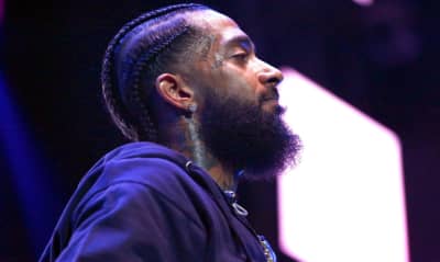 The man Nipsey Hussle was buying clothes for during fatal attack has been arrested for associating with the rapper