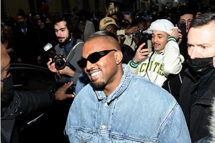 Kanye West leaving his office in a red and blue checkered jacket and  carrying a large Louis Vuitton luggage bag Featuring: Kanye West Where: Los  Angeles, CA, United States When: 10 Oct