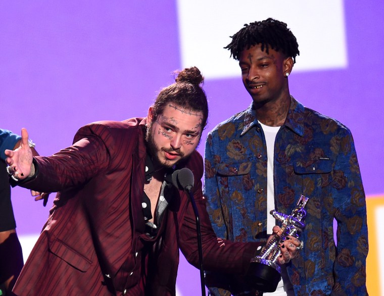 Recording artists 21 Savage (L) and Post Malone appear backstage after  winning the top Rap Song award for 'Rockstar,'' during the 2018 Billboard  Music Awards at MGM Grand Garden Arena on May